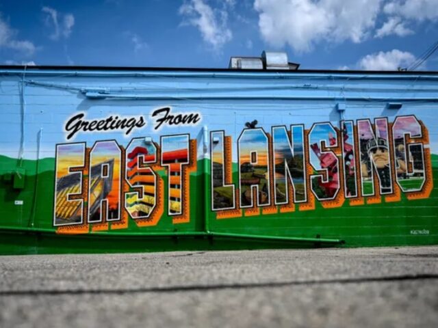 Side of a building painted with the words Greetings from East Lansing