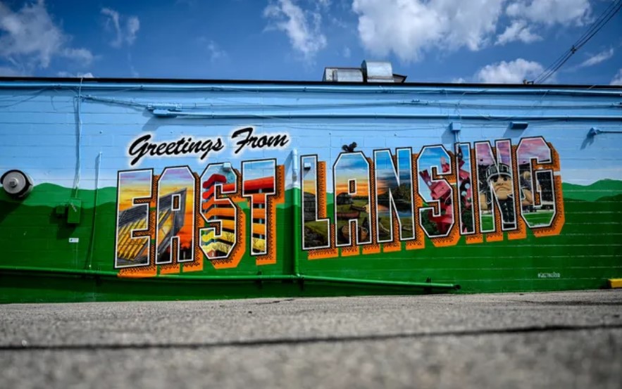 Side of a building painted with the words Greetings from East Lansing