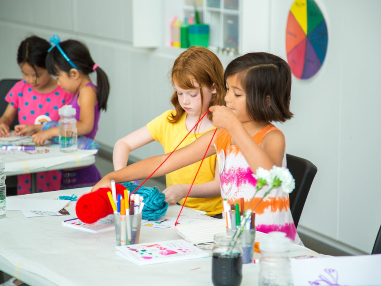 Photo of little kids making art with string