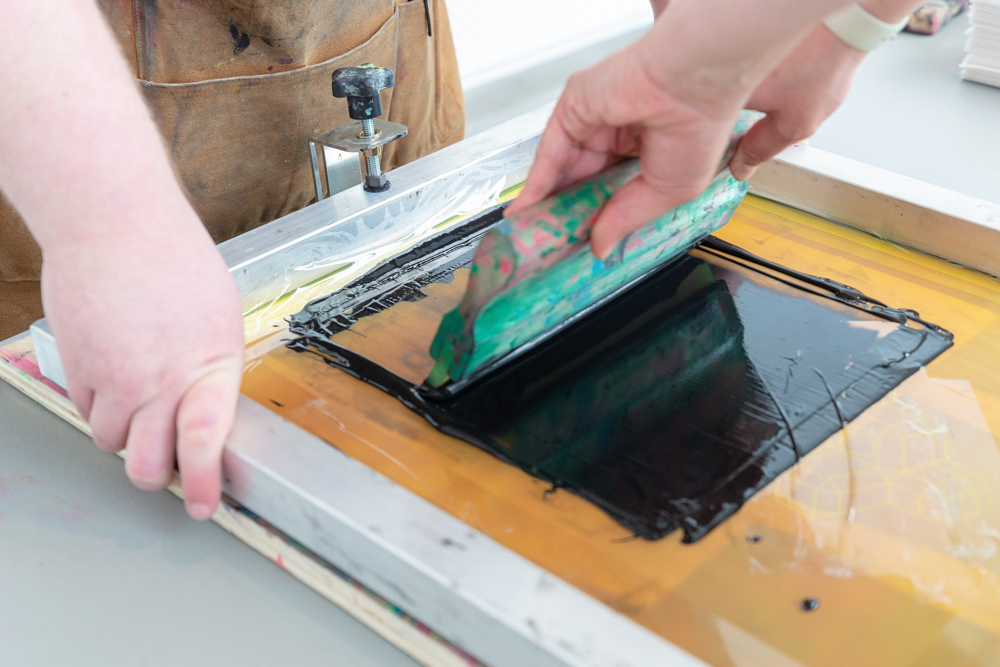 photo of a person screen printing