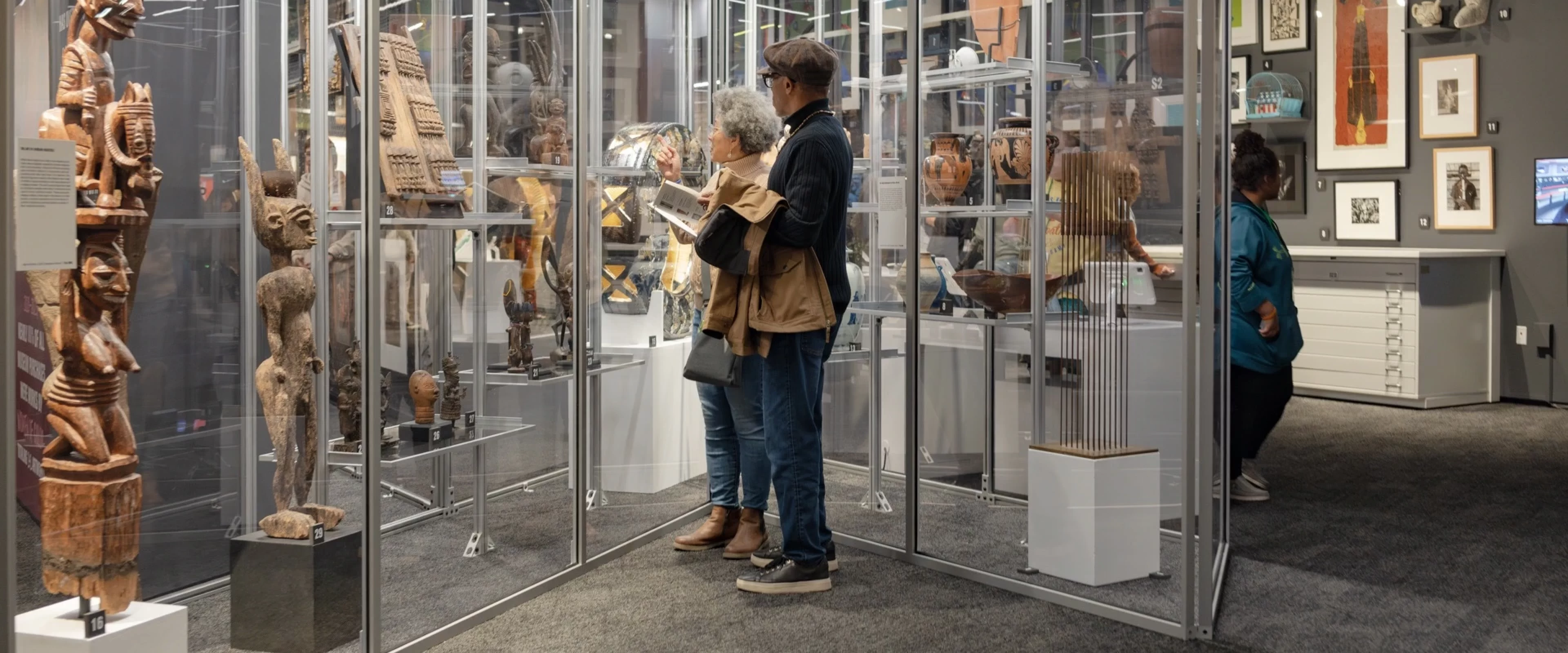 Two adults looking at collection of historic sculptures
